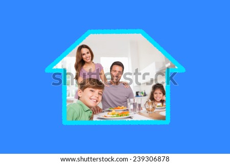 Family looking at the camera at dinner time against blue vignette