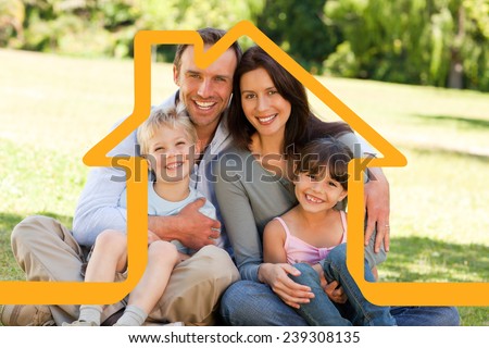 House outline against family sitting in the park