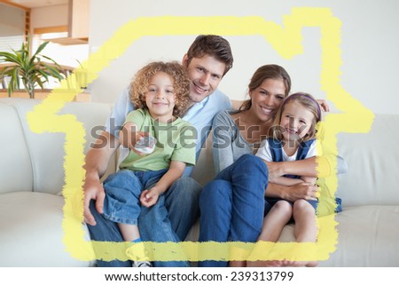 Smiling family watching TV together against house outline