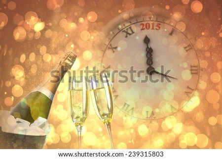 Clock counting to midnight against sparkling wine