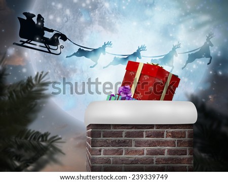 Composite image of santa flying his sleigh against full moon over forest