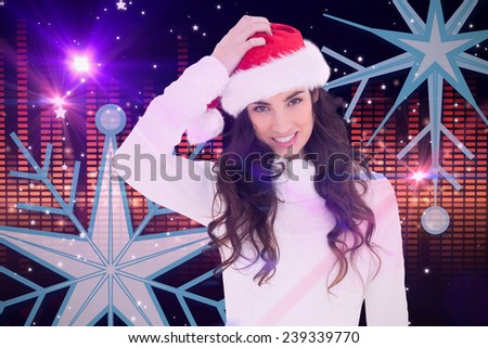 Confused brunette in santa hat against digitally generated disco light design