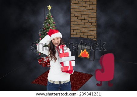 Stressed brunnette in santa hat holding gifts against dark background