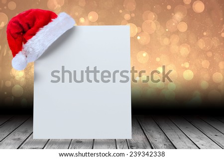 Santa hat on poster against yellow abstract light spot design