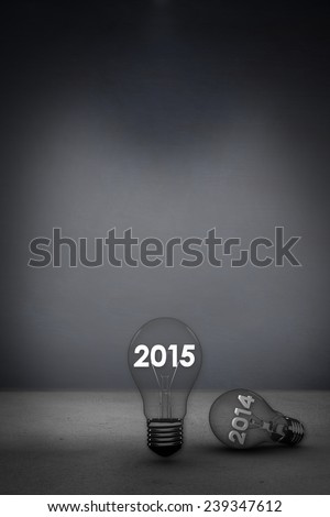 2014 and 2015 in light bulb against grey room