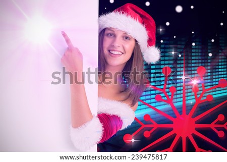 Pretty girl in santa costume showing card against digitally generated disco light design