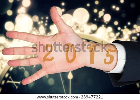 Hand with fingers spread out against black and gold new year graphic