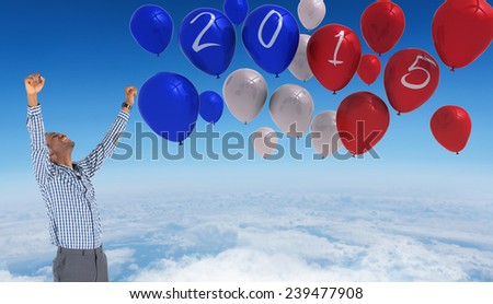 Excited businessman cheering against blue sky over white clouds