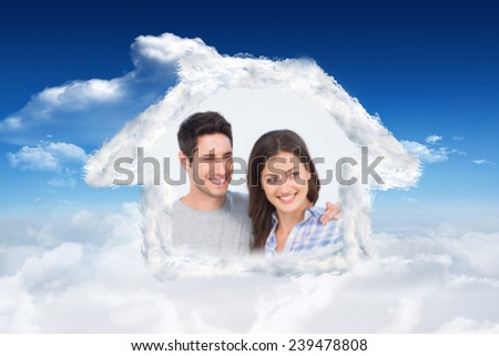 Woman being given a house key against bright blue sky with clouds