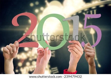 Hands holding poster against black and gold new year graphic