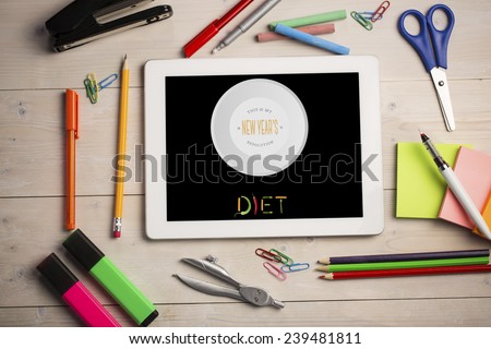 Diet new years resolution against students desk with tablet pc