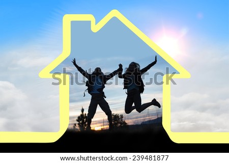 Silhouette couple jumping against the sky against blue sky with white clouds
