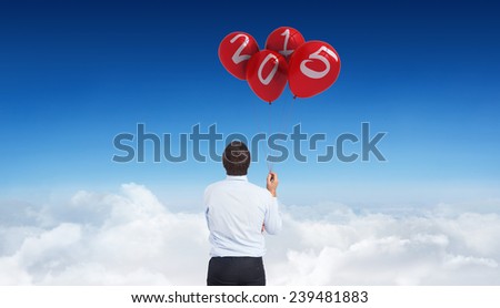 Thinking businessman holding pen against blue sky over clouds