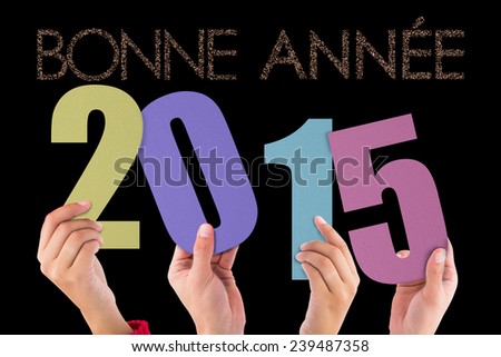 Hands holding poster against glittering bonne annee