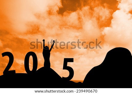 Cheering female silhouette against cloudy skyline