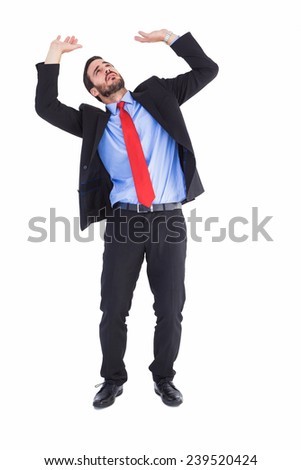 Worried businessman standing and pushing up on white background