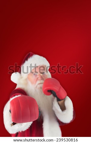 Santa Claus punches with his right against red background