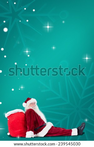 Santa sits leaned on his bag against green snowflake background