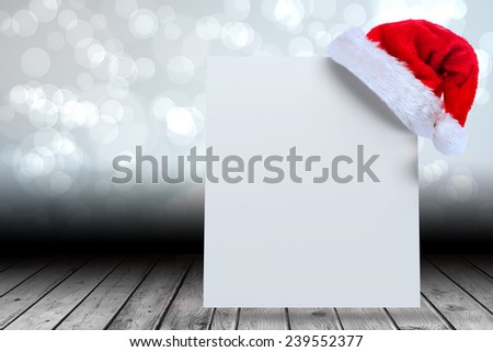 Santa hat on poster against light glowing dots design pattern