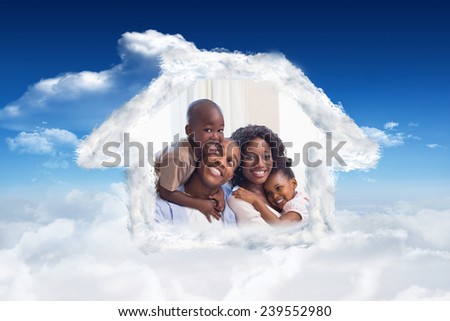 Happy family posing on the couch together against bright blue sky with clouds