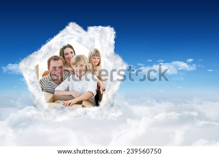 Loving family packing boxes against bright blue sky over clouds