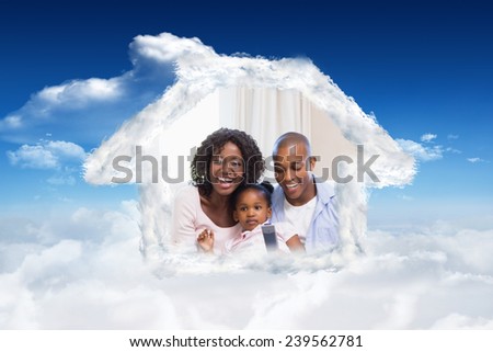 Happy family watching television together against bright blue sky with clouds