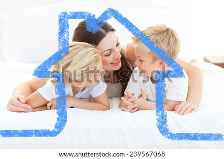 Merry children and their mom discussing lying on a bed against house outline