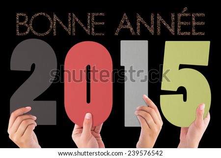 Hands holding poster against glittering bonne annee