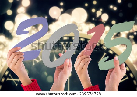 Hands holding poster against black and gold new year graphic