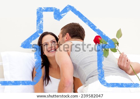 Husband giving a rose and a kiss to his beautiful wife against house outline