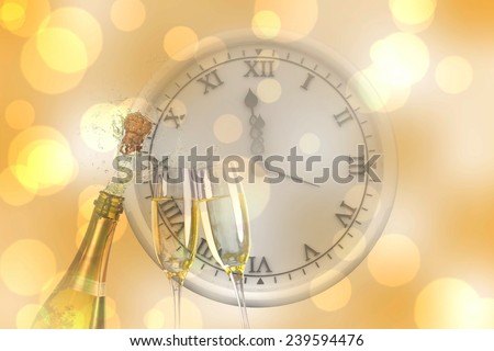 Clock counting to midnight against sparkling wine