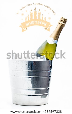 Merry Christmas message against bottle of champagne chilling in ice bucket