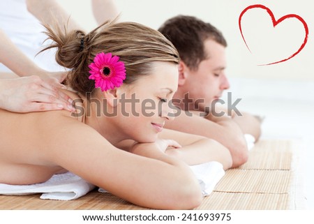 Relaxed young couple receiving a back massage against heart