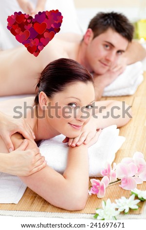 Happy couple receiving a back massage against heart