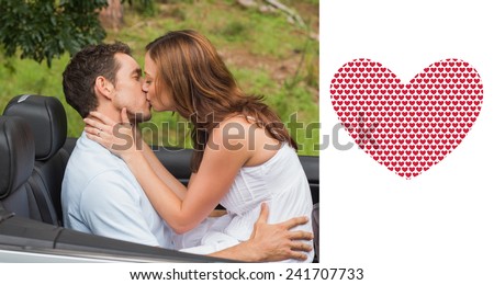 Beautiful couple kissing in back seat against valentines day pattern