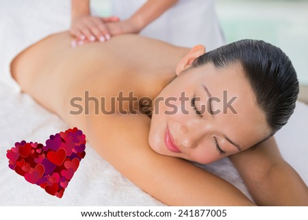 Content brunette enjoying a back massage against heart
