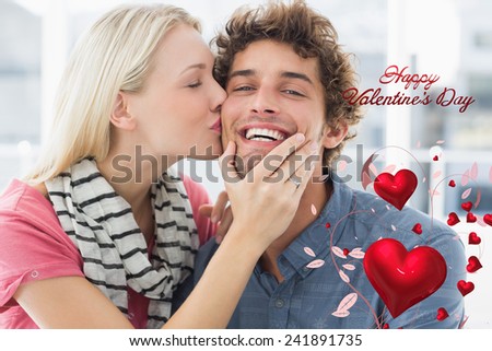 Woman kissing man on his cheek against cute valentines message