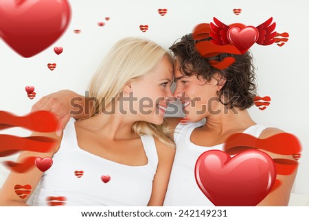 In love couple looking at each other against love heart pattern