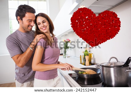 Woman preparing food at the stove against red love hearts