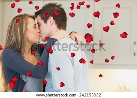 Hugging and kissing couple against valentines heart design