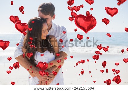 Loving couple cuddling against red heart balloons floating