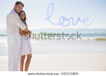 Attractive couple hugging and looking at camera against love