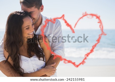 Attractive couple cuddling against smoke heart
