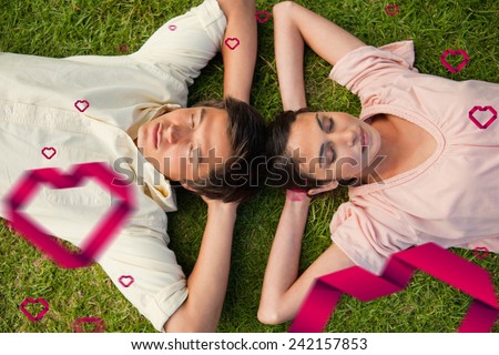 Two friends lying head to head with both hands behind their neck against hearts