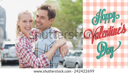 Couple in check shirts and denim hugging each other against happy valentines day