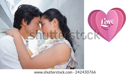 Happy couple hugging each other against love heart