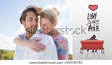 Smiling couple standing outside together against love is in the air