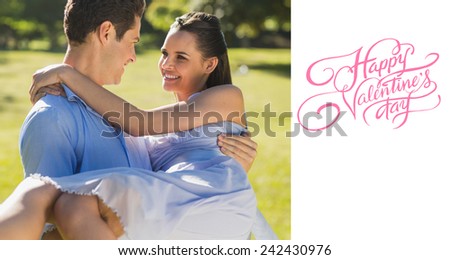 Man carrying woman in park against happy valentines day