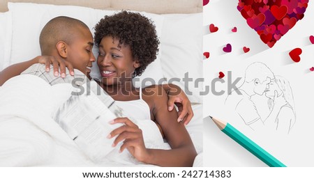 Happy couple lying in bed cuddling against sketch of kissing couple with pencil