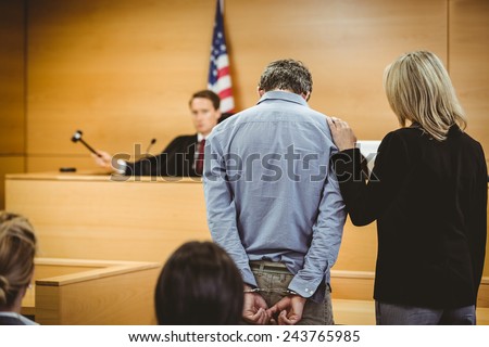 Judge about to bang gavel on sounding block in the court room